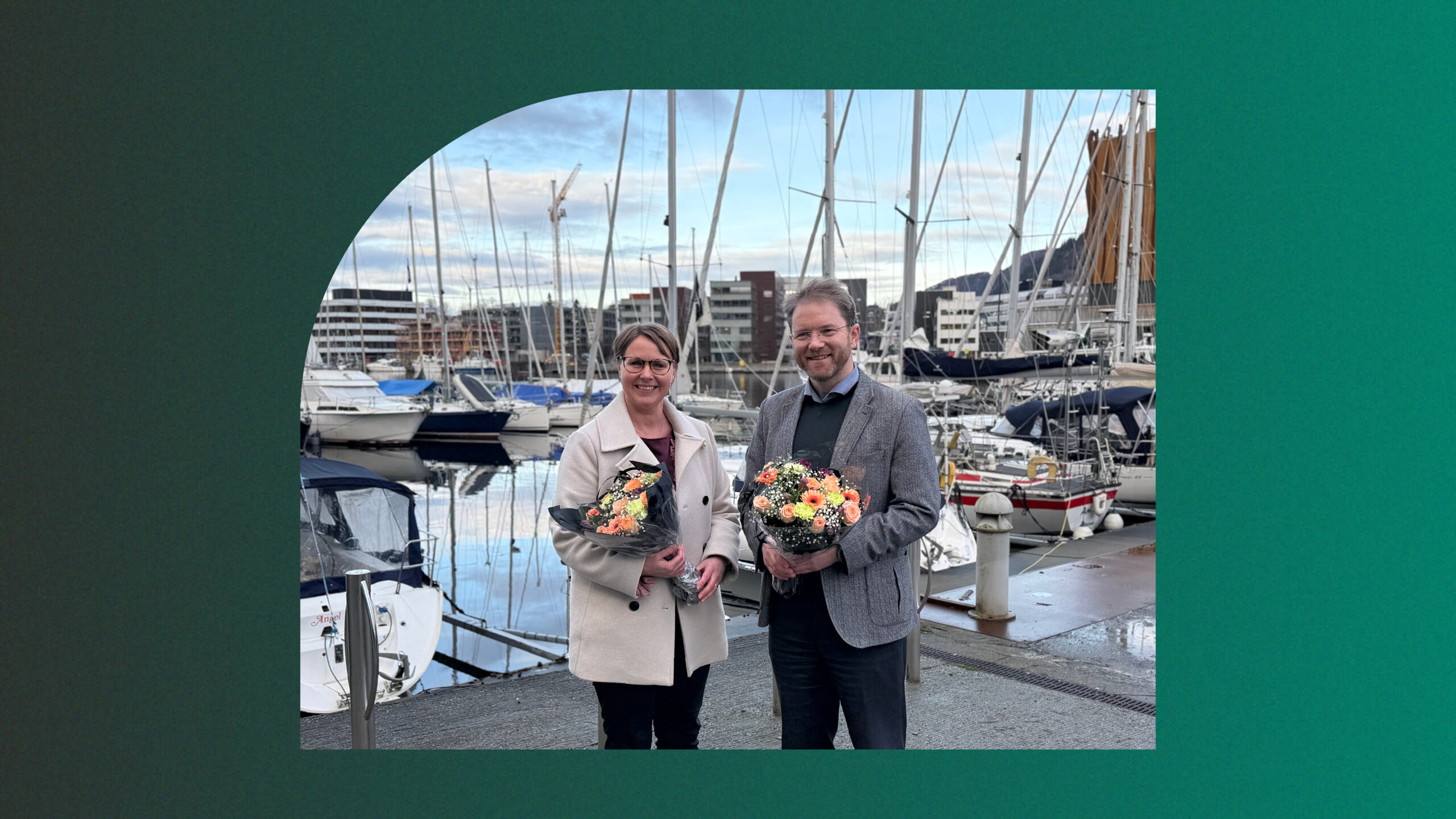 Bilde av Bodil Valland Steinhaug og Tor Instanes, henholdsvis konstituert administrerende direktør og avtroppende administrerende direktør i GC Rieber Eiendom, med blomster i hendene.